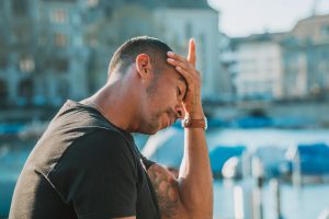 man with his hand on his forehead