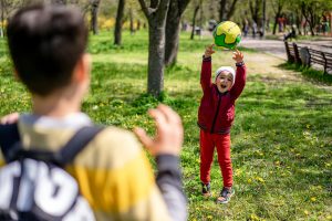 kids outside playing with a ball