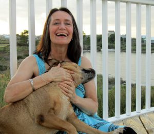 woman laughing holding a dog