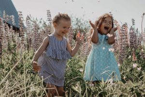 2 young girls laughing outside