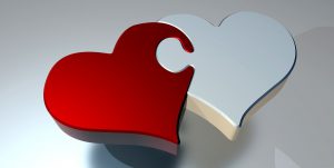 red heart and white heart connecting together like puzzle pieces