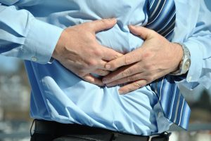 man holding the side of his stomach