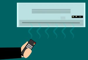 illustration of a hand holding a remote with an HVAC system in the wall