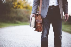 man in a suit walking with a briefcase