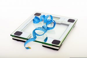 weight scale with measuring tape on it