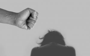woman looking down with a fist over her head