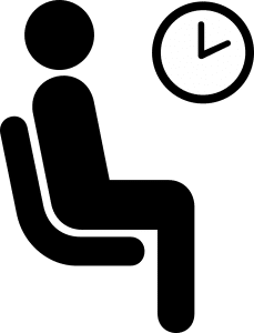 person sitting waiting with a clock nearby