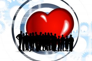Illustration of a large group of people standing in front of a large red heart