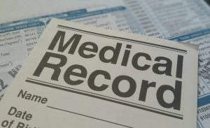 medical record paperwork on desk