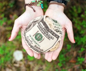 hand with a ball of money