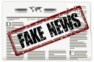 fake news stamped on newspaper