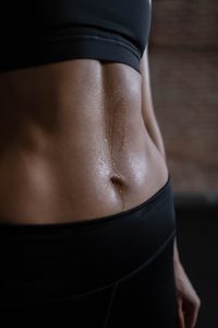 picture of a womans flat stomach sweating