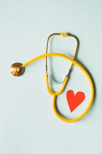 yellow stethoscope surrounding a red heart