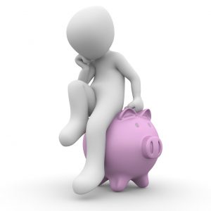 a person sitting on a pink piggy bank