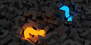 a bunch of gray question marks piled together with one blue and one orange question mark in the pile
