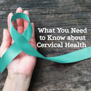 a hand holding a cervical cancer awareness ribbon over a wooden table with the article title written in white