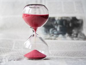 picture of an hourglass with red sand 