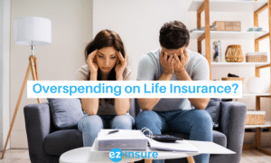 overspending on life insurance? text overlaying image of a couple looking at their finances stressed out